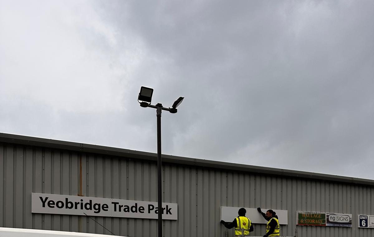 Yeobridge Trade Park fascia sign being installed on a building elevation, with tenant and haulage signage visible alongside