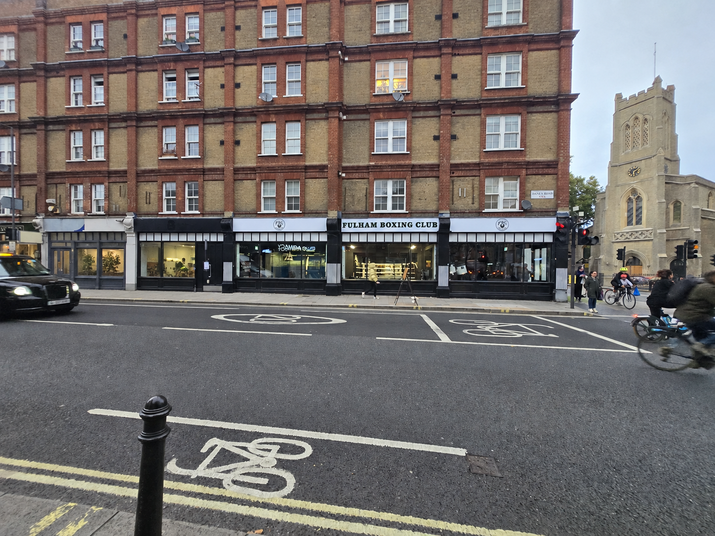 Fulham Boxing Club’s white signage seen from across the busy junction.